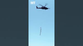 Special ops troops dangle from a Black Hawk helicopter during SPIES extraction at SOF Week 2024