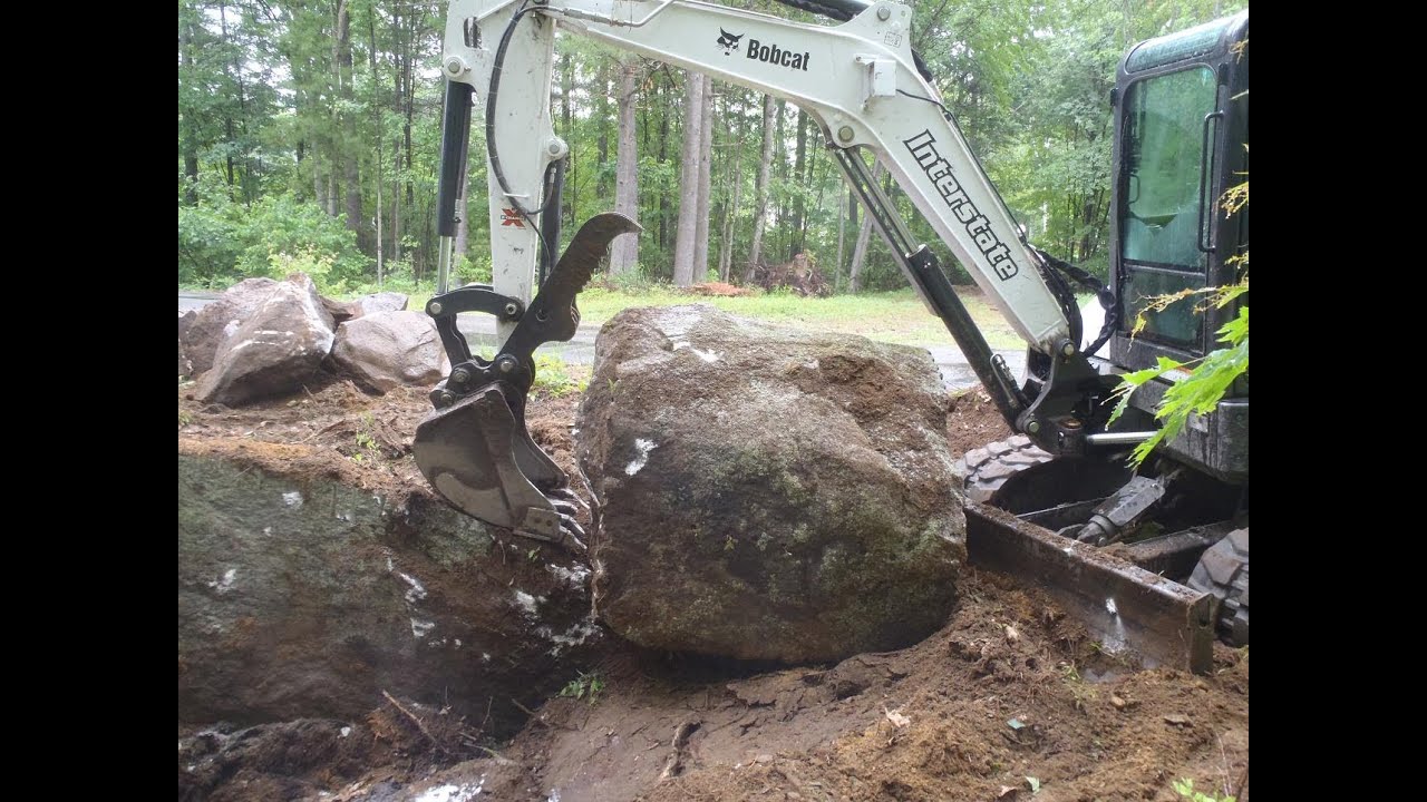 Bobcat E50 Wrestling Two Huge Rocks