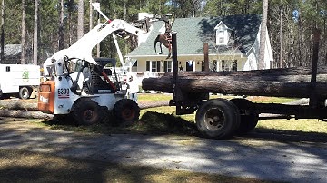 Loading logs with Bobcat  S300 and grapple attachment - Tree Service in Raleigh, Wake Forest, NC