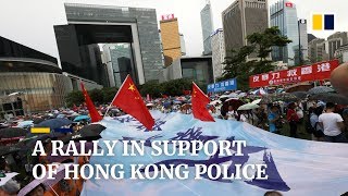 Tens of thousands brave the rain to show support for Hong Kong police
