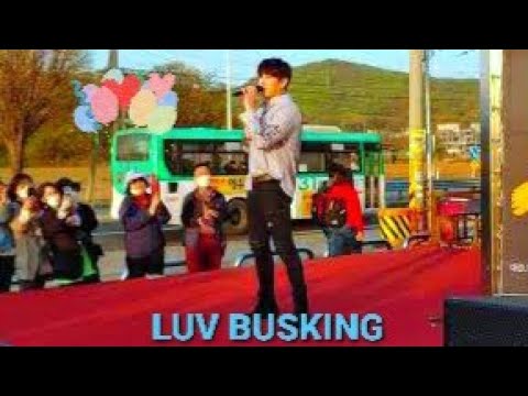 DECEMBER DK. ENJOYING HAPPY BUSKING ON LOCAL SUPERMARKET STAGE.