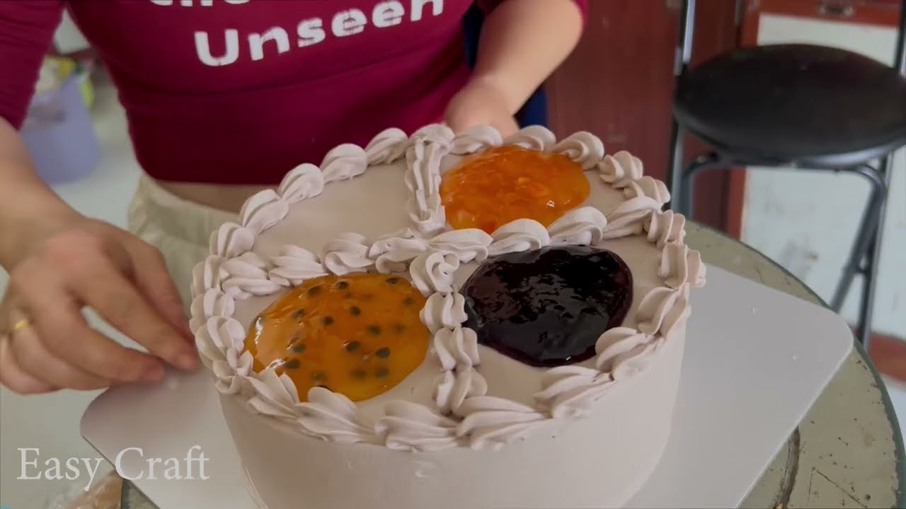 Decorate cake with chocolate and passion fruit sauce.