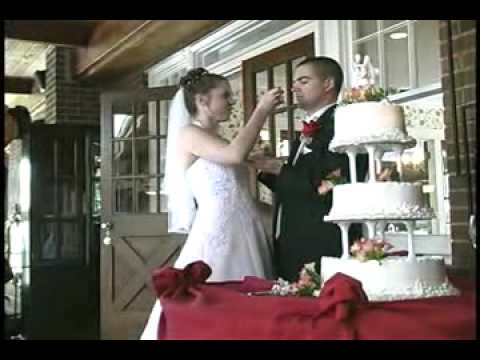 Leslie and Cameron eat cake at their wedding
