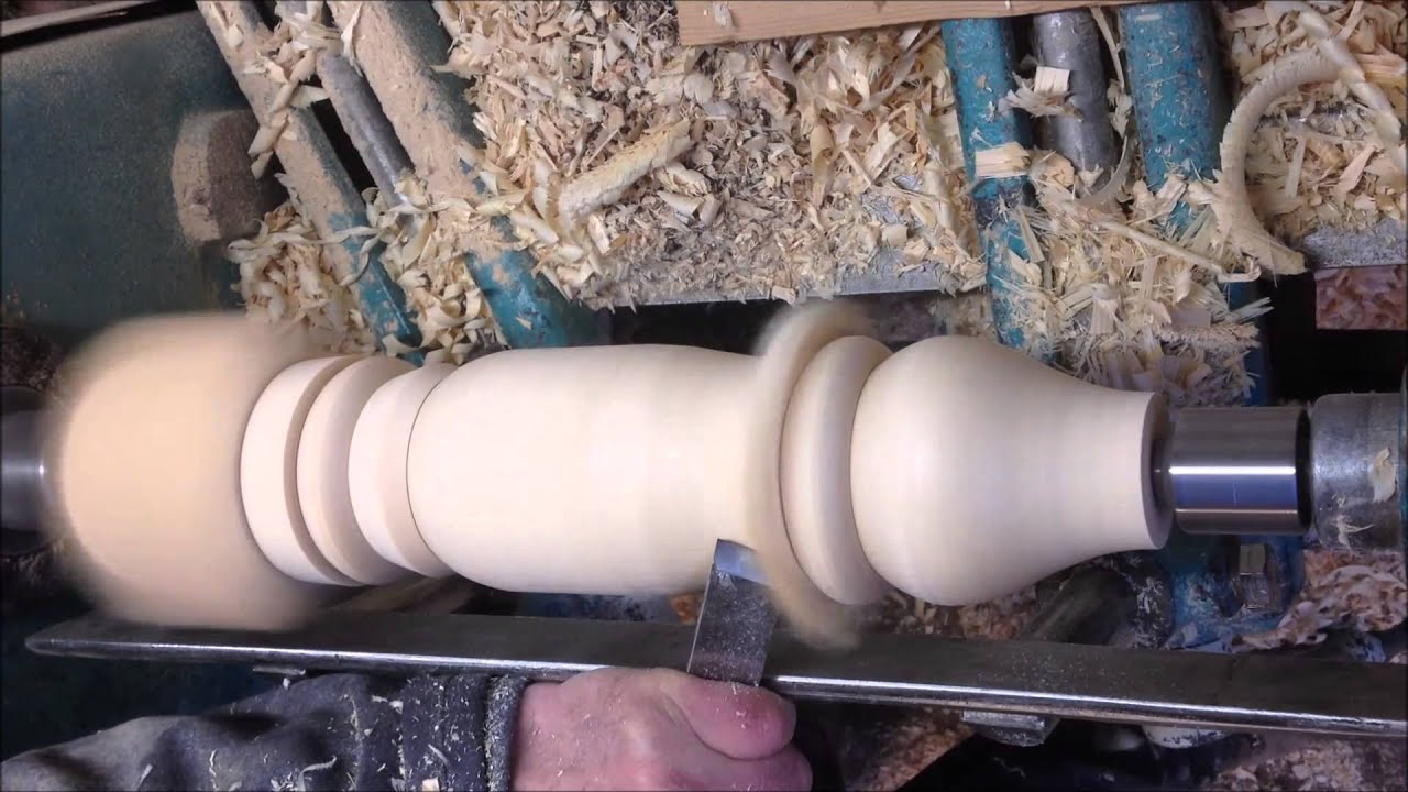 hand woodturning a coffee table leg