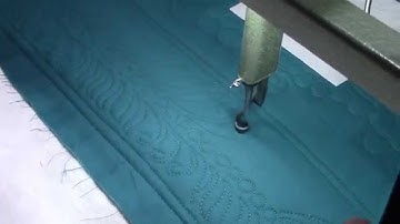 Ann Longarm quilting a feather.