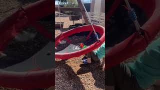Boy pushes red tire swing that comes back and hits him on his face