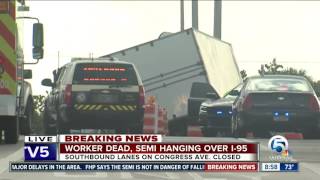 Tow truck worker dies after semi crashes, hangs from overpass
