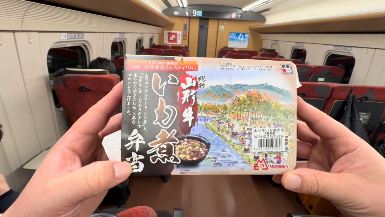 A Japanese salaryman eating ekiben on the Shinkansen.