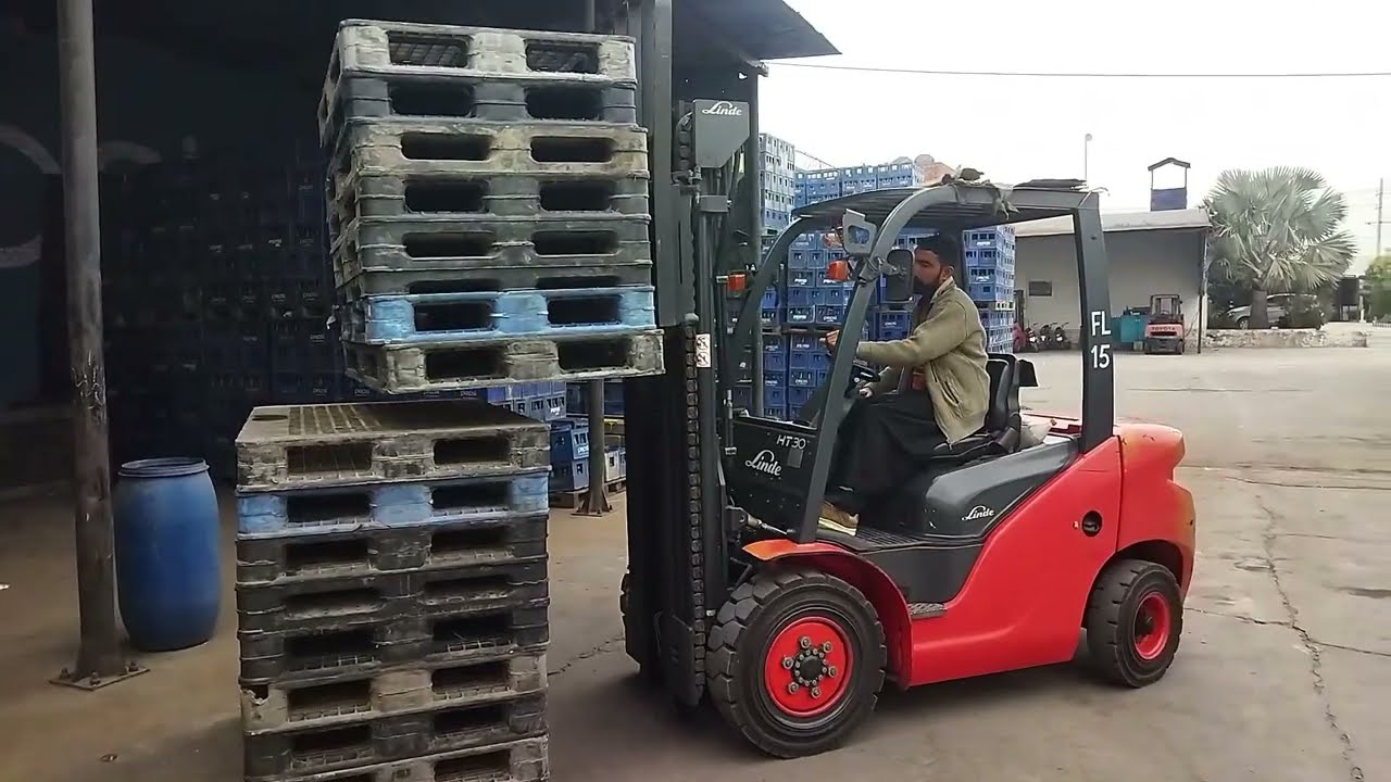 Sit Down Forklift Truck Loading Pallets In Warehouse 