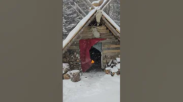 cozy fire during winter storm in my bushcraft shelter