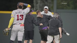 Braves’ Ronald Acuña Jr. knocked to the ground after two fans run onto Coors Field