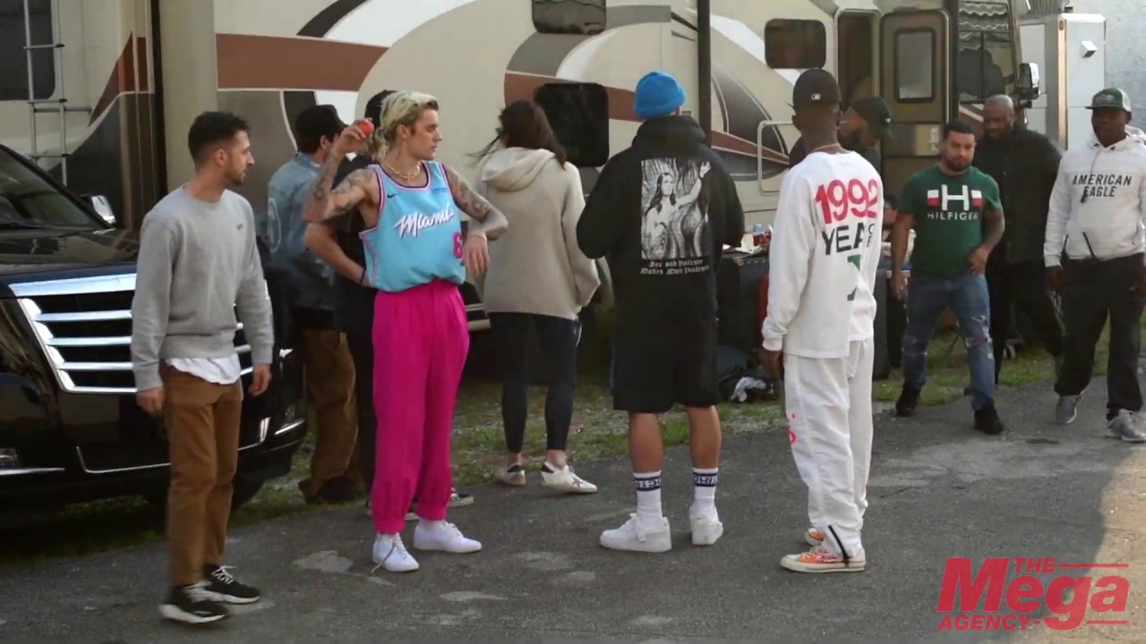 Justin Bieber wears a colorful Miami Heat jersey as he shows off his hockey skills on set in Miami