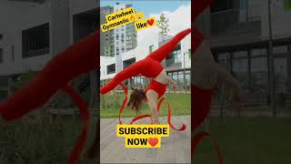 Red Outfit Young Women Performing Cartwheel Gymnastic
