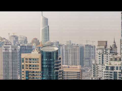 Aerial top view of Dubai Marina morning timelapse. Modern towers and traffic on the road