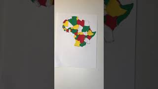 Assemble an Africa puzzle on a sheet of paper