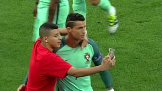 Cristiano Ronaldo takes pictures with fans during semi final Euro 2016