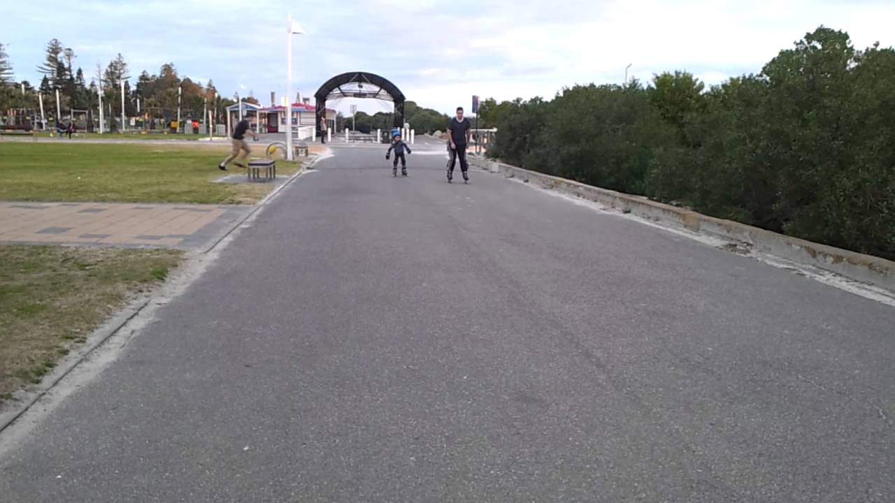 Dad and son learning to rollerblade