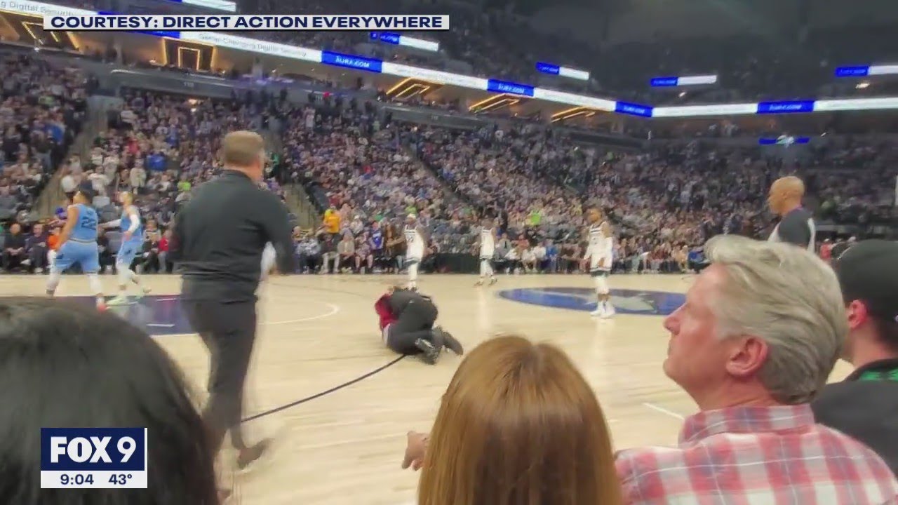 Security guard tackles another protester at Minnesota Timberwolves