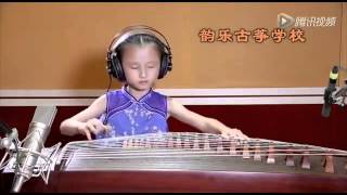 Chinese Kid of age 5+ playing Koto instrument