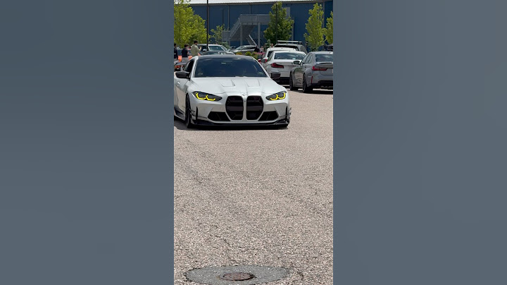 CRAZY bmw M4 Competition in Frozen white with yellow headlights.