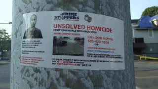 Crime Stoppers Unsolved Homicide Poster For Larry Morales, Jr. on a Lamp Post at the Corner of Dewey