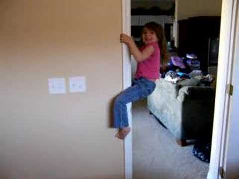 little girl climbing a wall
