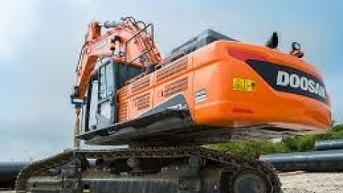 Old Hero in Action: Caterpillar 245B Excavator with Over 120,000 Working Hours Loading Overburden