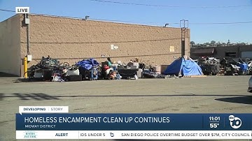 Garbage crews help clean up homeless encampment in Midway