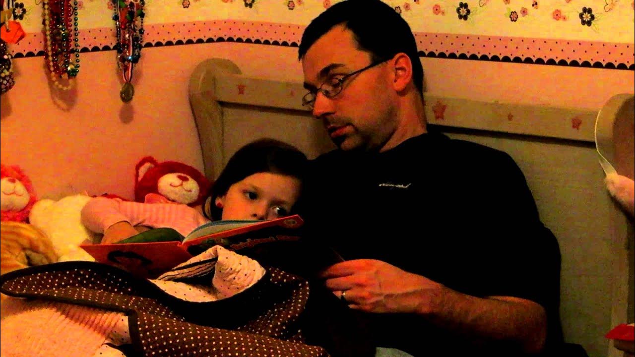 Daddy falling asleep while reading to our little girl