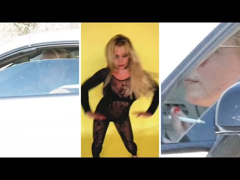 Britney Spears lights up a cigarette while taking her car out for a drive