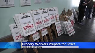 Community members help grocery workers prepare signs, potential strike