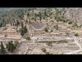 Delphi, Greece. Ruins of the ancient city of Delphi. Sunny weather, Summer. Aerial View, Departur...