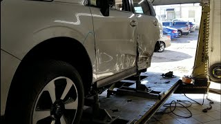 A GLIMPSE OF A SUBARU FORESTER SIDE AND QUARTER PANEL BEING REPAIRED / REPLACED.