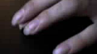 Gio taps his fingernails on a table