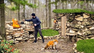 Building a barbecue fireplace near a stone hut | photo hunting