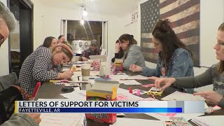 Volunteers write letters for human trafficking victims