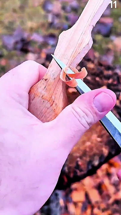 Carving wood outdoors with curled shaving detail