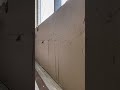 Smoothing a wall using white cement for a clean finish