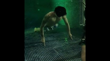 Jungkook doing under water push-ups with one finger