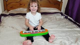 Little Girl Playing Mary Had A Little Lamb On Toy Keyboard