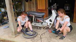 The girl mechanic helps people in the village repair motorbikes