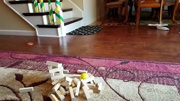 Tower of jenga blocks falling in slow motion