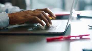 close up hands man african american young uses laptop typing touch work in office programmer sunligh