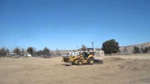 HEO Michael Constantin Grading with the skip loader/grader.