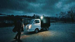 Car Camping. small pickup truck during heavy rain