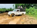 Mahindra bolero 4x4 escaping through a slippery mud surface.