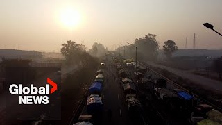 India farmer protests: Hundreds of trucks block highway to New Delhi