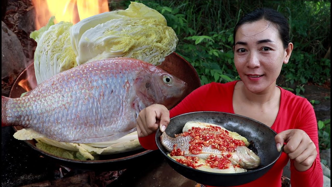 Burn Cabbage with red fish at river eating delicious