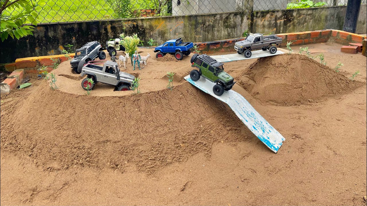 RC car action driving over obstacles and bridges to reach heights,Rc Jeep Defender Bronco Toyota…