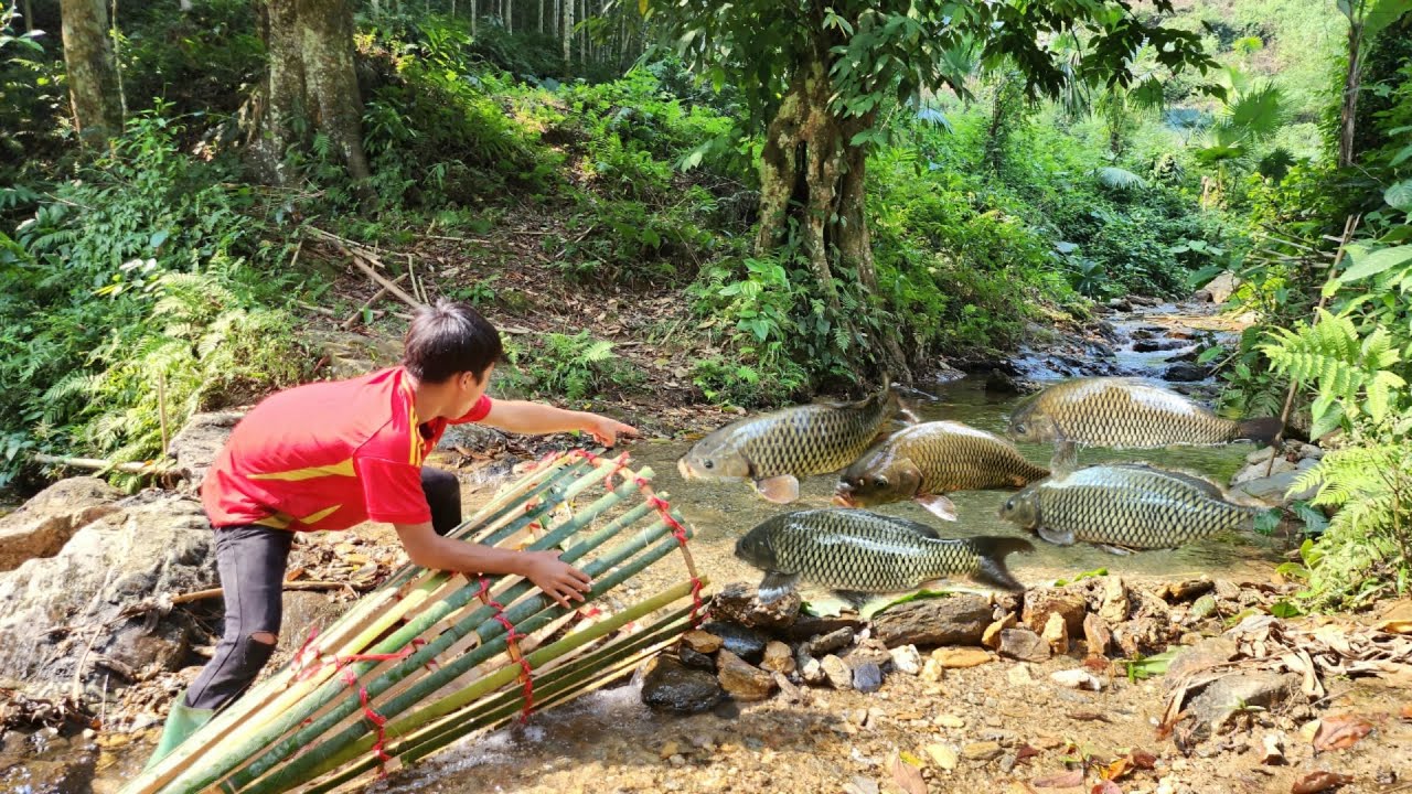 The boy wove bamboo to make a trap to catch fish in the stream ...